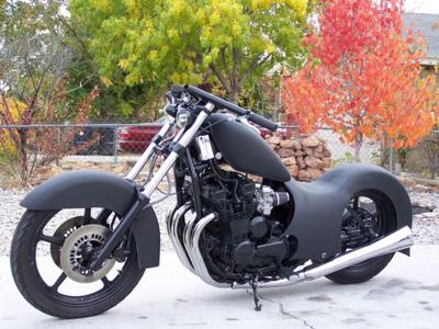 I want to know who built this black custom motorcycle